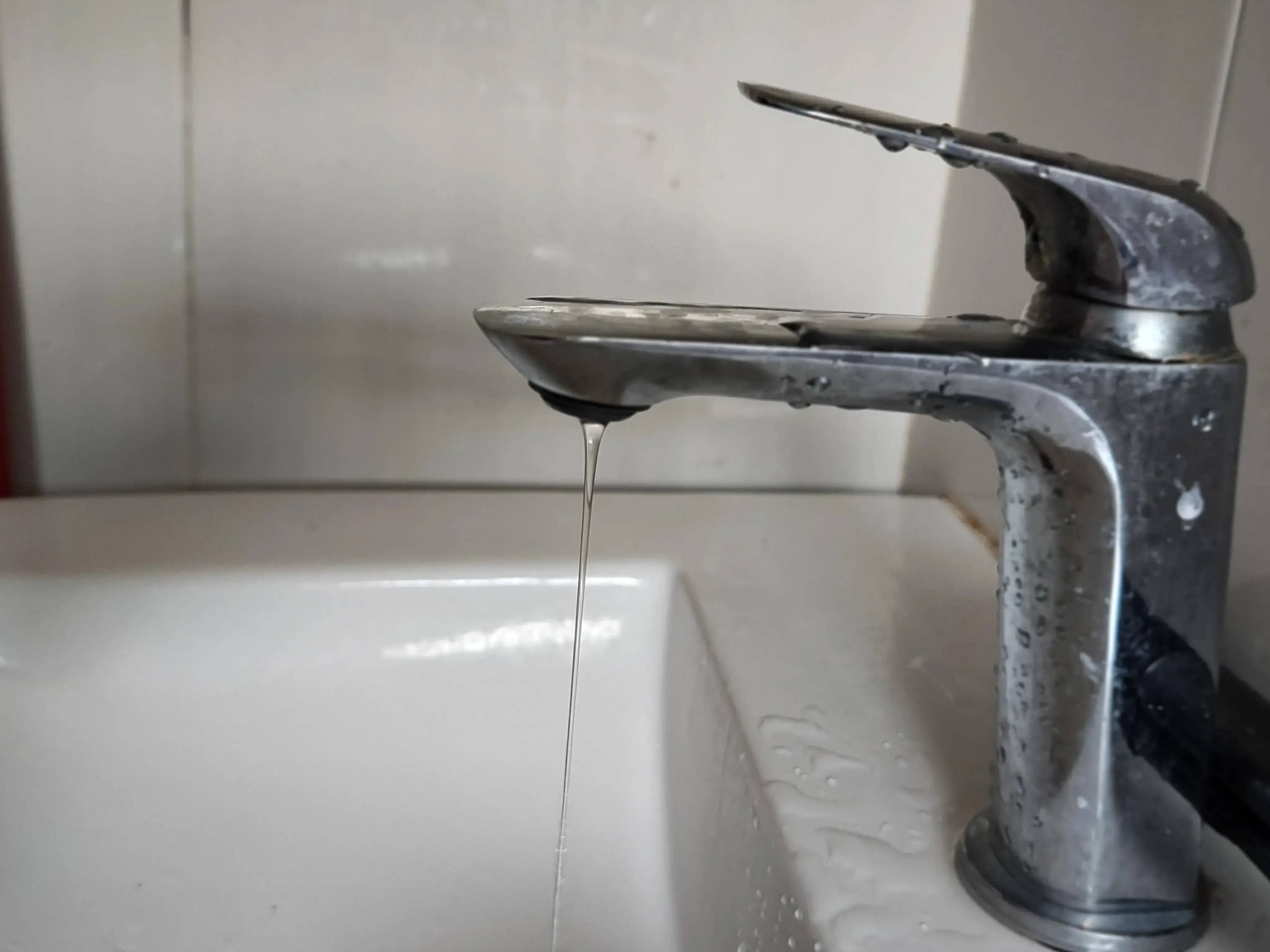 Step-by-step illustration of fixing a leaky bathroom faucet, showing the repair process