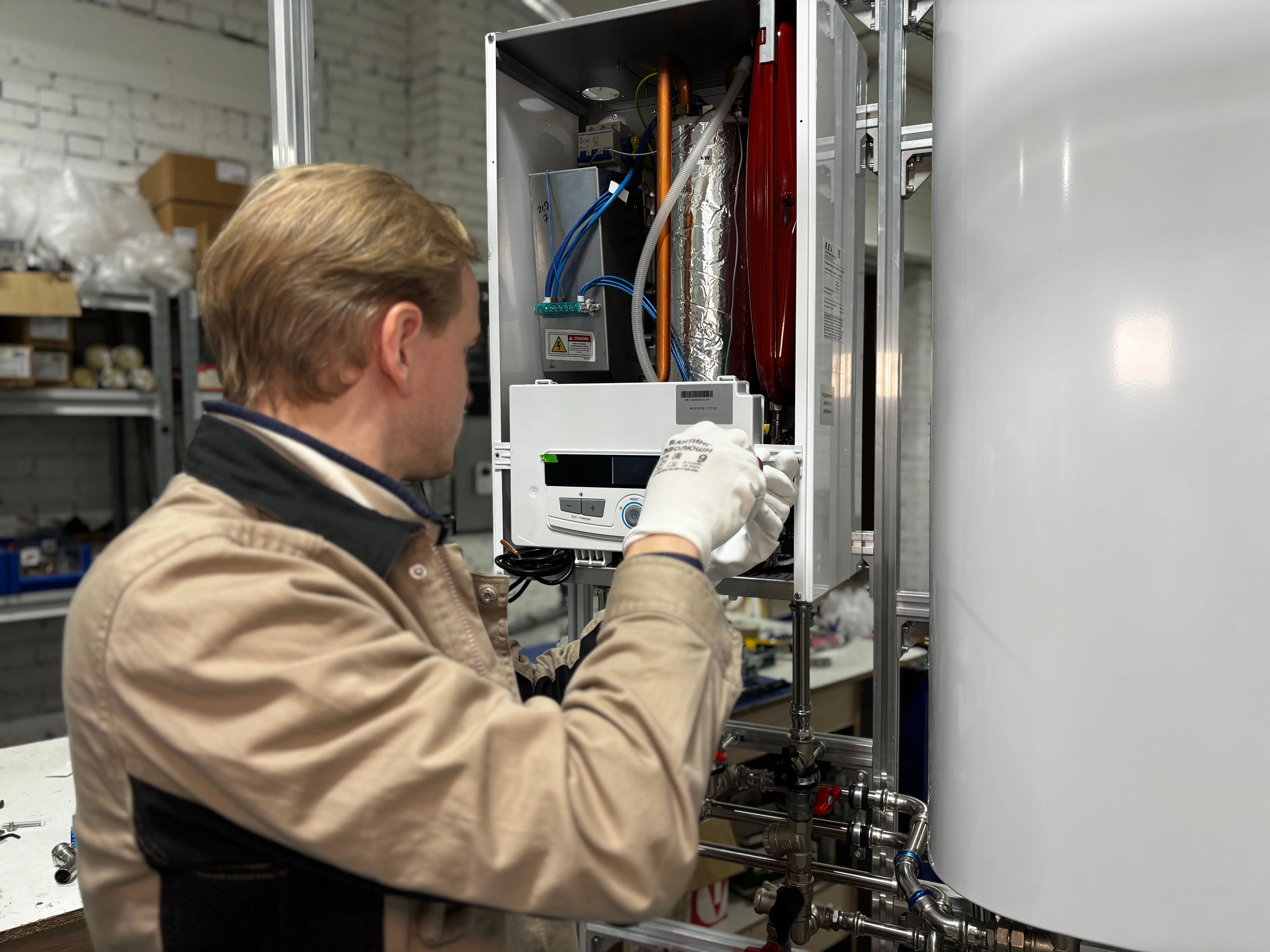 Technician actively repairing and servicing a heating system unit, illustrating hands-on water heater maintenance.