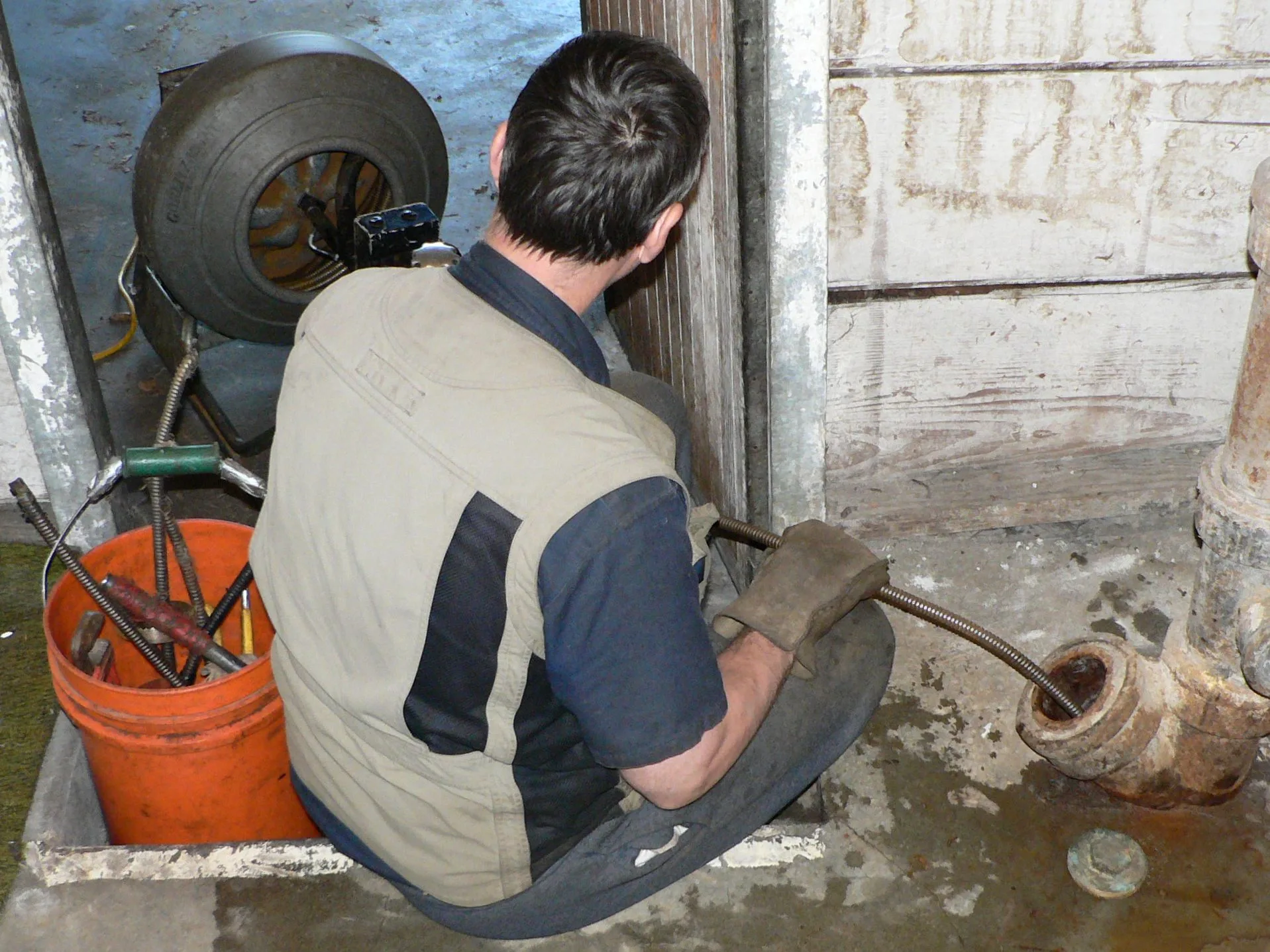A coiled plumber's snake (drain auger) tool used to clear clogged sink and drain pipes.