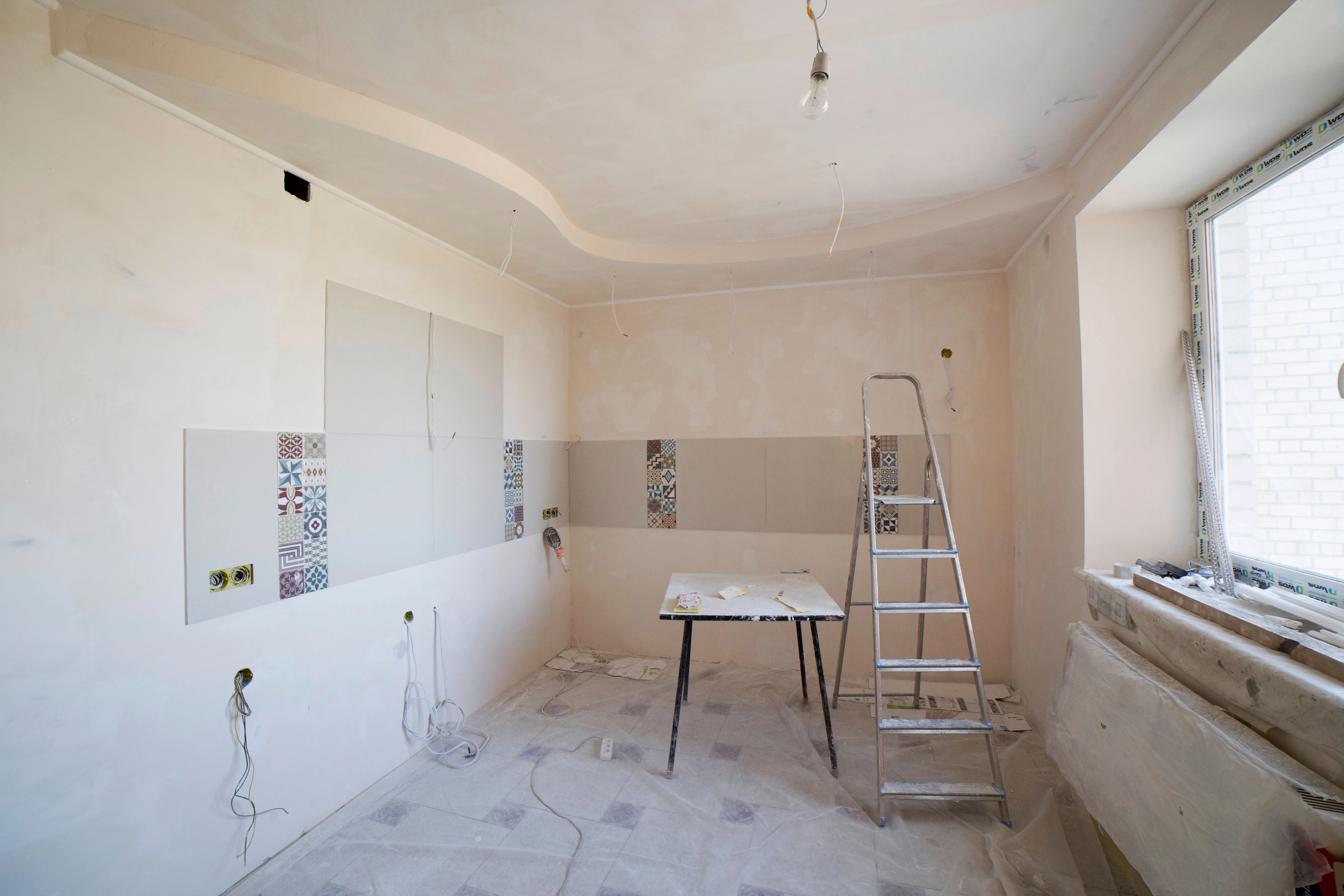Modern kitchen interior mid-renovation, showing an unfinished remodel in progress.